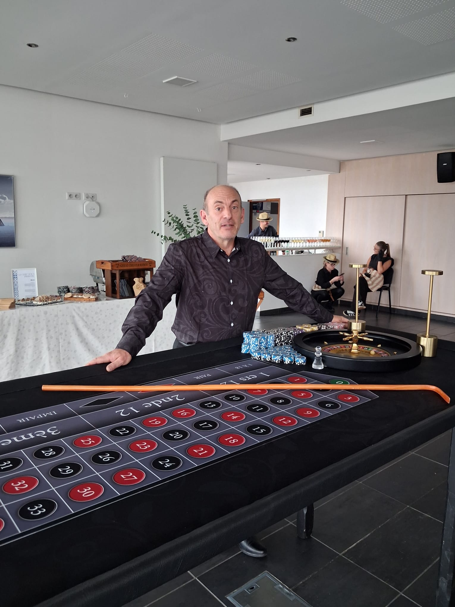 Croupier professionnel animant une table de roulette anglaise avec jetons et râteau pour un événement d'entreprise à la Marina du Château.